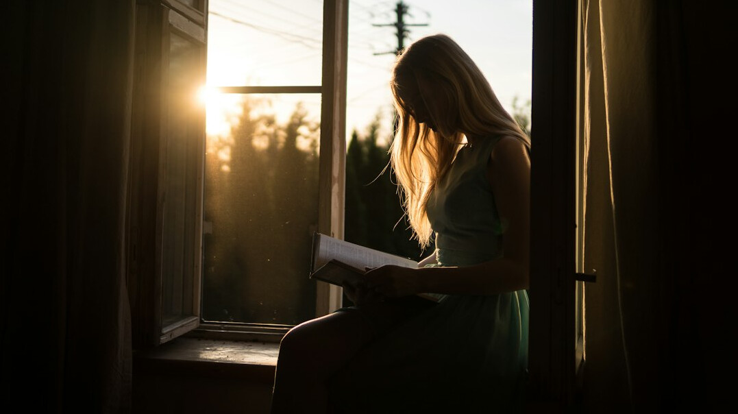 woman reading self help book