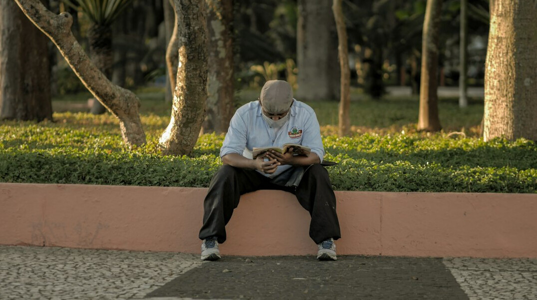 Brazilian man reading a notebook while studying personal development topics